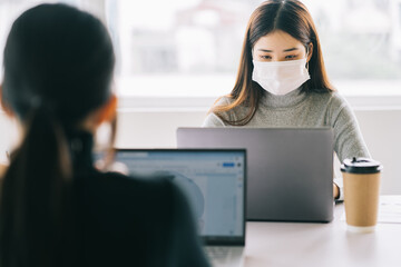 Two women have to wear masks during working hours to stay safe during epidemics
