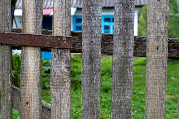 Elements of an old wooden fence on a ranch on a summer day.