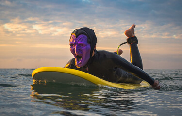 Halloween Costume Surfing Various scary costumes worn by a surfer while riding waves in Japan. Pumpkin, Monster, clown, witch. The waves are clean with a good looking sunrise as well