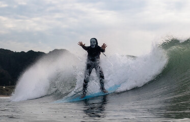 Halloween Costume Surfing Various scary costumes worn by a surfer while riding waves in Japan. Pumpkin, Monster, clown, witch. The waves are clean with a good looking sunrise as well