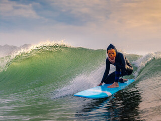 Halloween Costume Surfing Various scary costumes worn by a surfer while riding waves in Japan. Pumpkin, Monster, clown, witch. The waves are clean with a good looking sunrise as well