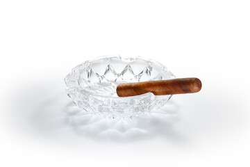 close up view of nice robusto Cuban cigar and ashtray on white back 