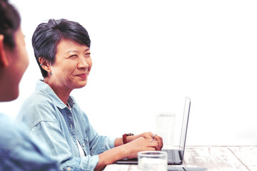 Happily middle-aged designer woman, teacher, or mentor coach speaking to young people, Asian female business leader speaker talking at the meeting. Isolated white background. Active Elderly concept.