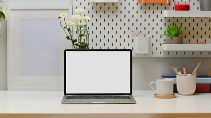 Modern worktable with laptop, books, stationery, copy space and flower, clipping path