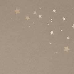 Shimmering gold stars on a beige background