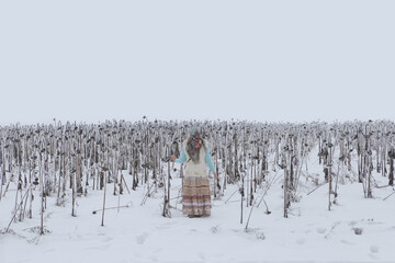 Russian style. Russian boho girl traditional national folk Pavlovo Posad shawl. Snowy field of...