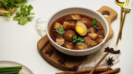 Thai food, sweet brown stewed eggs soup (Kai Palo) with pork on bamboo placemat