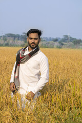 Indian farmer in standing in paddy field