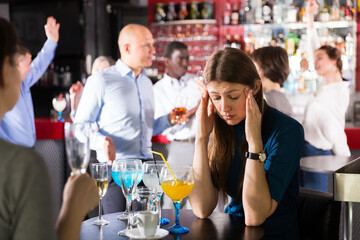 Portrait of sad woman bored at corporate party