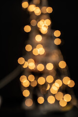 Festive bokeh light with golden yellow blurred lights, sparkling shiny vertical background