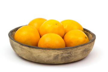 oranges in a clay bowl on white background