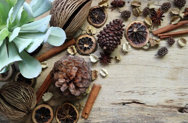 Naklejka na ściany i meble pinecones are on the wooden table with dried potpourri , spices, herbs, and plants for decoration during Christmas new year happy celebration party