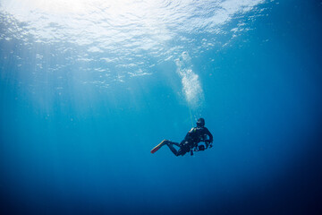 Fototapeta na wymiar Scuba Diver underwater of the big blue sea making safety stop after a dive.