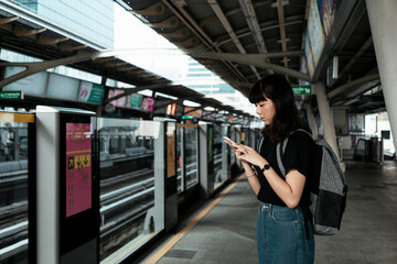 Woman waiting for train on platform.