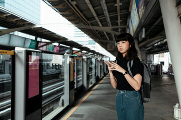 Woman waiting for train on platform.