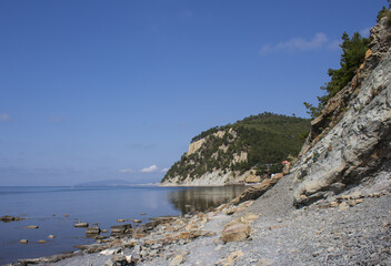 A picturesque landscape of a wild sea beach stretching along the rocks