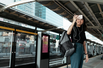 Thai backpacker waiting for a train.