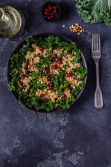 Healthy raw kale and quinoa salad with cranberry and pine nut.