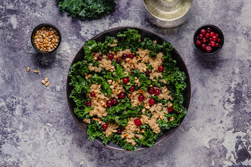 Healthy raw kale and quinoa salad with cranberry and pine nut.