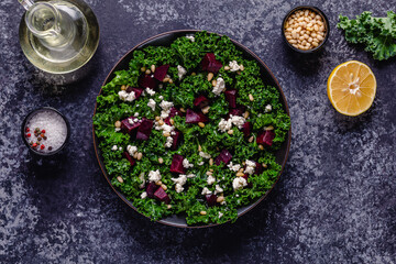 Healthy raw kale and beetroot salad with feta cheese and pine nut.