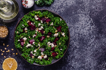 Healthy raw kale and beetroot salad with feta cheese and pine nut.
