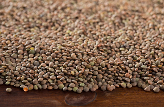 Raw lentils on a wooden surface. High quality photo