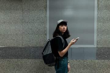 Copy space - traveler woman using smartphone at metro station.
