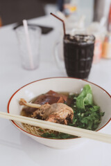 Braised duck leg noodles in a spiced broth served with tofu, pork blood and lettuce this is delicious local cuisine food of Thailand or Asia region, Street food in Thailand