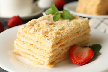 Concept of tasty lunch with Napoleon cake on gray wooden background