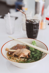 Braised duck leg noodles in a spiced broth served with tofu, pork blood and lettuce this is delicious local cuisine food of Thailand or Asia region, Street food in Thailand