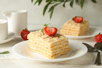 Concept of lunch with Napoleon cake on white wooden background