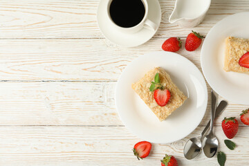 Concept of lunch with Napoleon cake on white wooden background