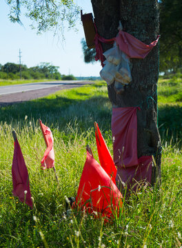 Places of memory of national hero Gauchito Gil and red flags along roads in Argentina