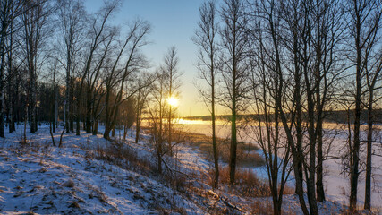 frosty winter over the river, sunset