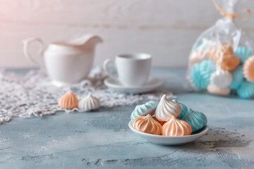Romantic Breakfast with meringue cookies, white cups and creamer