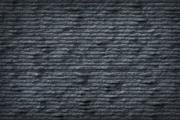 Dark grey black slate stone with groove texture abstract background