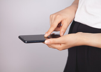 Woman using smartphone. The concept of using the phone is essential in everyday life.