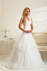 Fototapeta na wymiar Bride in a luxury apartment in a wedding dress.