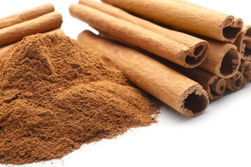 Cinnamon sticks and powder on white background, closeup