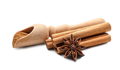 Scoop with cinnamon powder, sticks and anise on white background