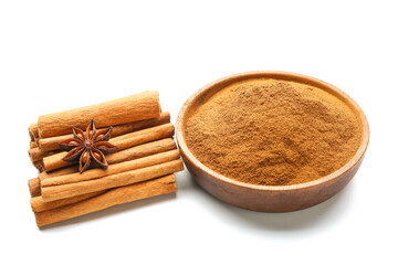 Bowl with cinnamon powder and sticks on white background