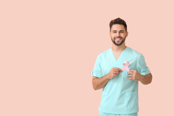 Doctor with pink ribbon on color background. Breast cancer awareness concept