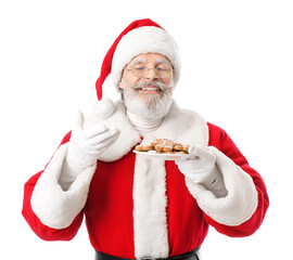 Santa Claus with tasty gingerbread cookies on white background