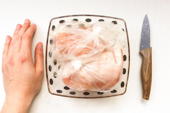 Chicken Fillet In A Bag Is Defrosted In A Plate. Chicken Fillet In A Plate.