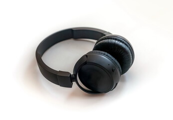 Fototapeta na wymiar Black wireless headphones for audio electronic devices close up on white background