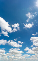 Fantastic clouds against blue sky, vertical panorama