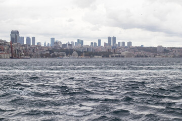 Obraz premium Panoramic view of the Istanbul city skyline seen from the sea. View of the Bosphorus and Dolmabahce Palace
