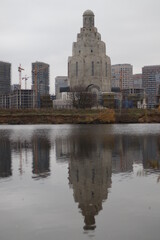 A body of water with a city in the background