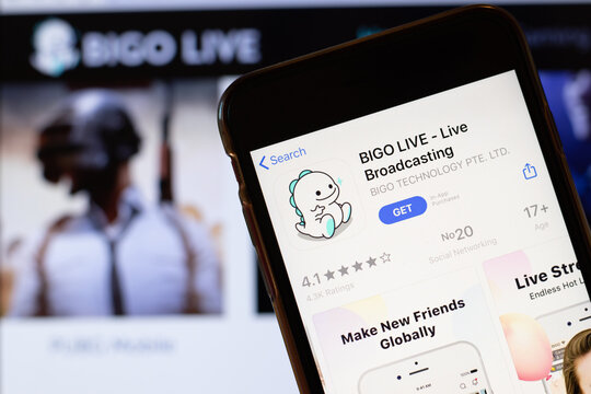 Los Angeles, California, USA - 24 March 2020: BIGO LIVE app logo on phone screen close up with website on background with icon, Illustrative Editorial
