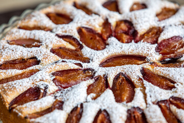Delicious plum cake sprinkled with powdered sugar